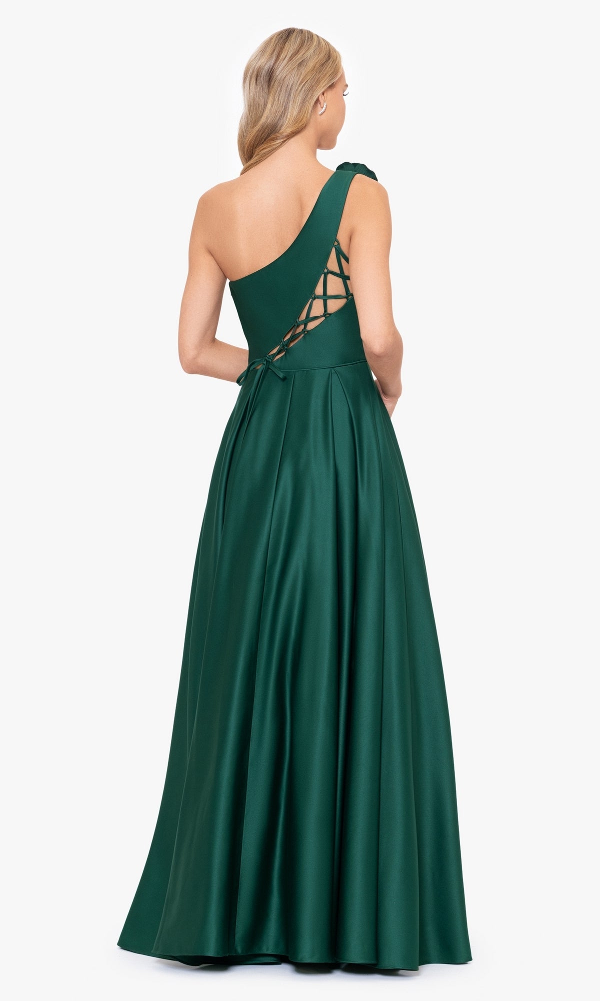 A woman wears the Hunter Green One-Shoulder Long Prom Dress 4600BN, featuring a floor-length A-line silhouette and lace-up back, standing against a plain white background.